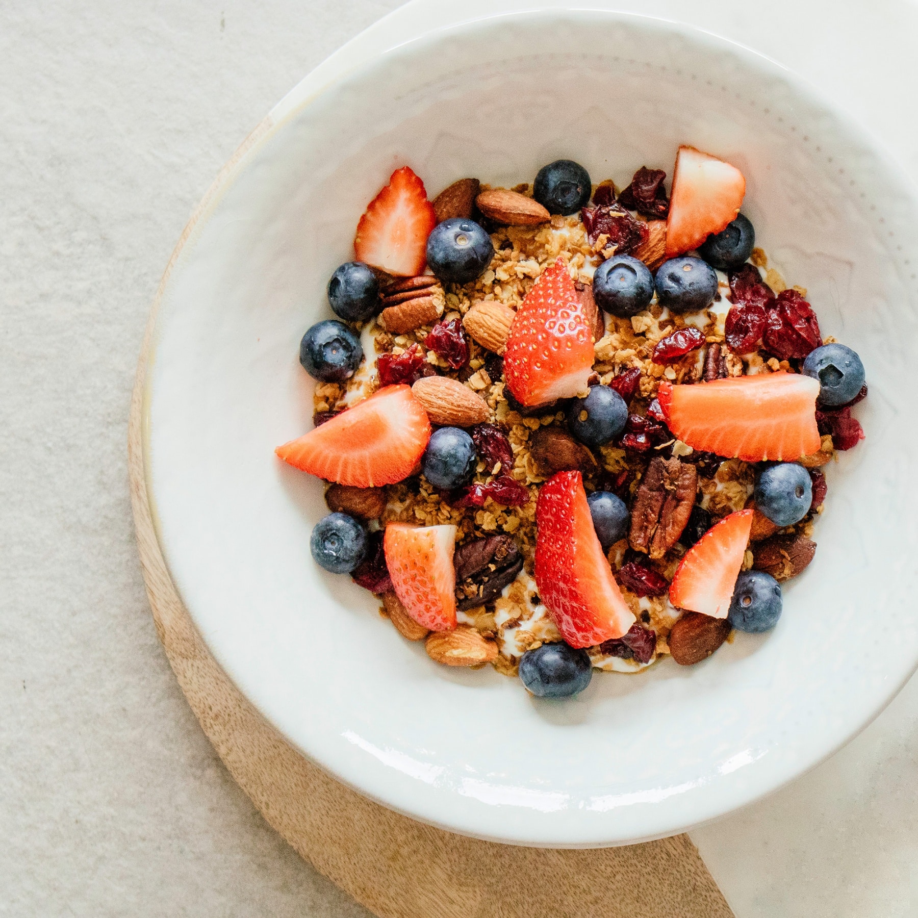 granola with strawberries and blueberries