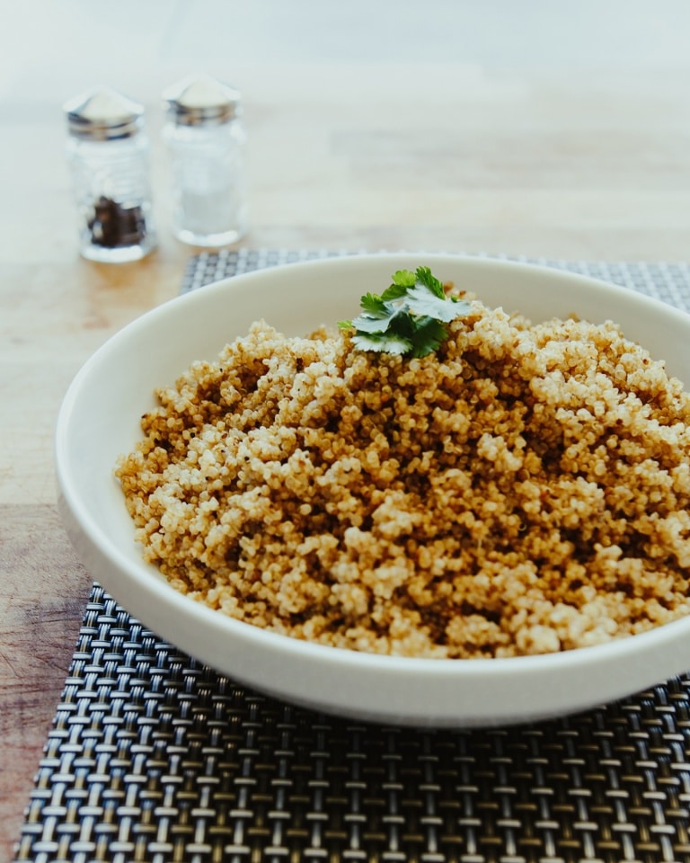 Cooked quinoa in a white bowl