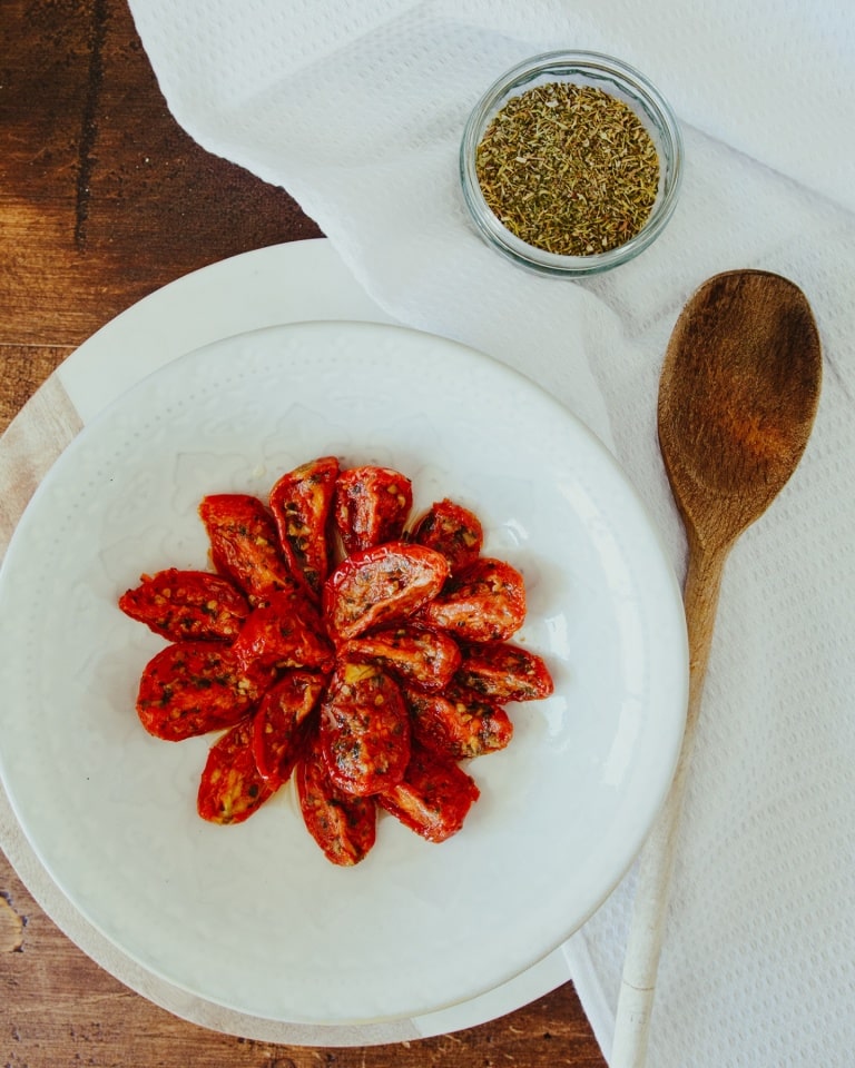 Slow roasted tomatoes with a spoon