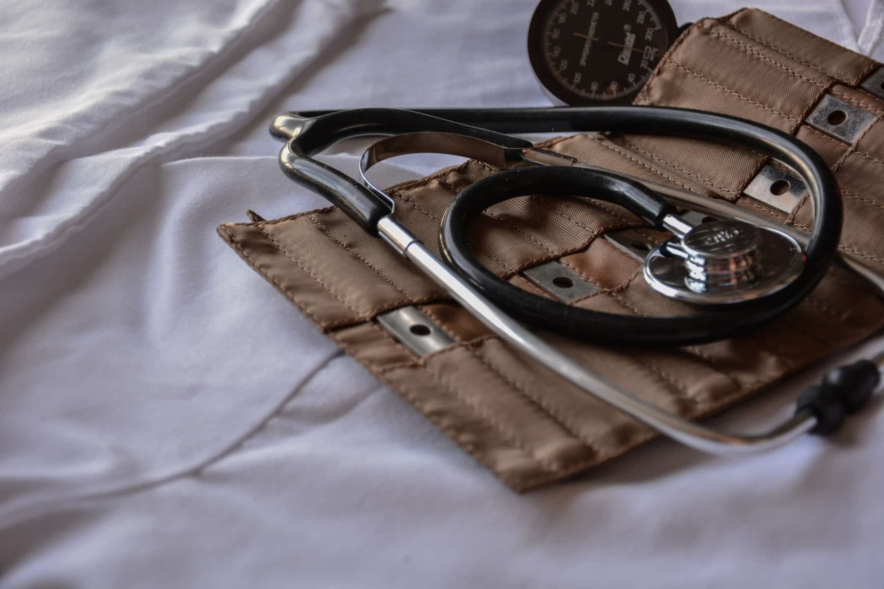 Black stethoscope with brow leather case